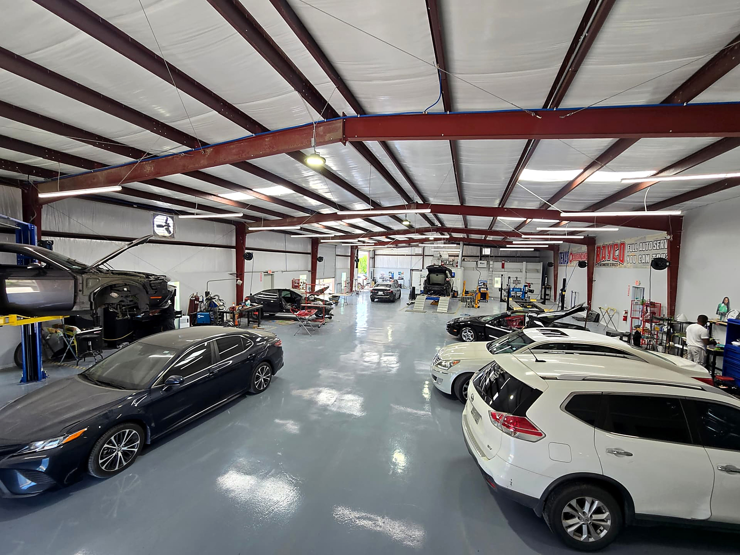 Wide view of the Rayco repair floor with vehicles in service