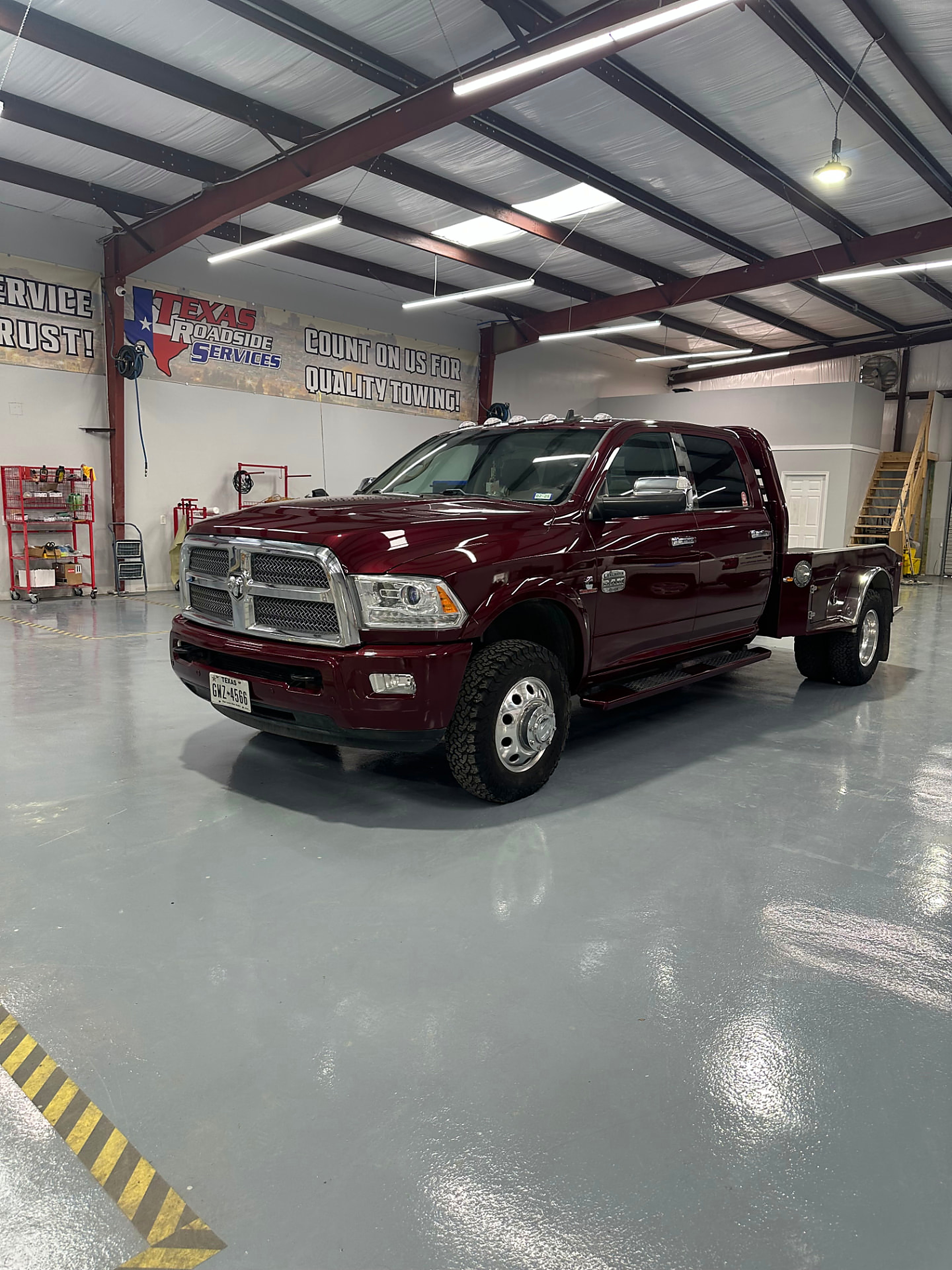 Maroon Ram dually flatbed detailed inside the Rayco shop